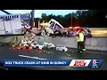 Box truck crashes onto highway barrier on Interstate 93 at Braintree split