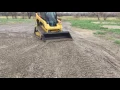 Dolar Excavation Billings Grading a gravel driveway with a cat 259d skid steer