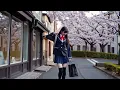 A Japanese schoolgirl walking down a street