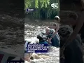 captures the mad scramble to help a female cyclist who got swept up in floodwaters