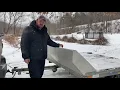 Loading and unloading snowmobile on tilt trailer