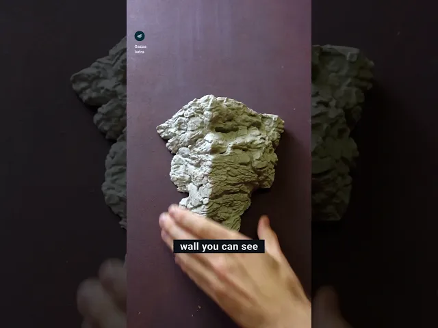 Rock wall shelf with face video thumbnail