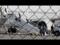 shows people in waist chains cuffs departing Utah on possible ICE plane