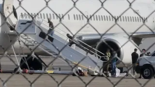 shows people in waist chains cuffs departing Utah on possible ICE plane
