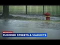 Cars stuck after driving through flooded streets in Little Village