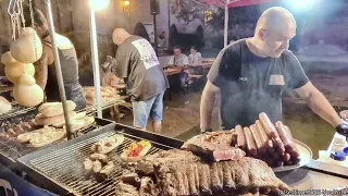 Big Grill of Beef, Hanging Melted Cheese and Sausages. Italy Street Food