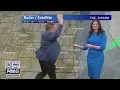 Rob Haswell helps Stephanie Barichello during weather hit FOX6 News Milwaukee