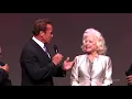Betty Weider with Arnold at the 2014 Olympia