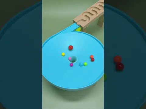 Colorful marbles are rolling into the hole. #satisfying