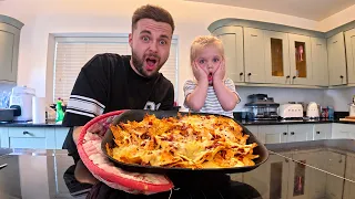 Cooking giant cheesy nachos (daddy and daughter)