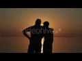 Happy Gay Couple Watching Sunset On The Beach - Stock Footage Hive 13092785