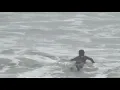 Surfers brave the rain at Manhattan Beach