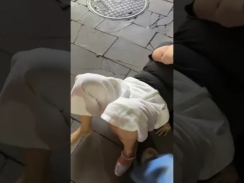 Woman falls while singing and walking backward in Guizhou, China