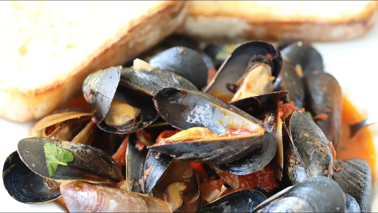 Learn how to clean, de-beard and cook Mussels in a tasty Tomato and Garlic Sauce. This Tomato, Garli. 