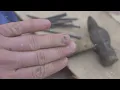 Worker examining bruised finger with dark hematoma under nail
