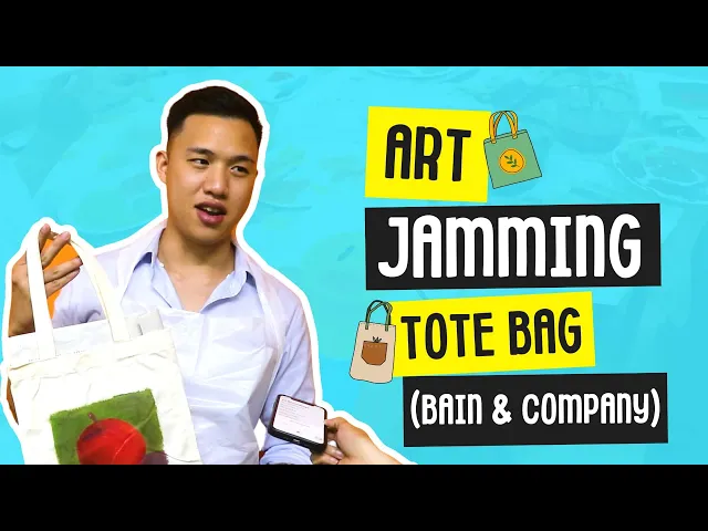 A Bain & Company participant shows the tote bag he painted