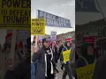 May Day protestors rally in front of Michigan Central in Corktown