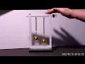 BOUNCING BRASS BALLS Micro-gravity between two objects revealed