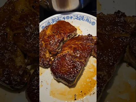 Steak and rosemary potatos on a stainless steel pan
