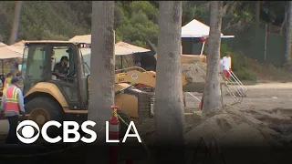 Waves from Hurricane Mare pushes tons of sand into Orange County parking lot