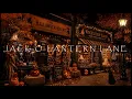 JACK-O-LANTERN LANE-HALLOWEEN AMBIENCE-COSTUME SHOP-WITCHES BREW BAKERY-FALLING LEAVES-BLACK CAT