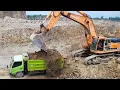 Download Lagu Truk Dam Bekerja Bersama Kapal Keruk Doosan Menggali Pasir dan Batu