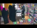 Girl is stealing from the shop using hers hijab