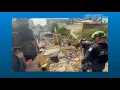 VA-TF 1 searching flattened buildings for survivors