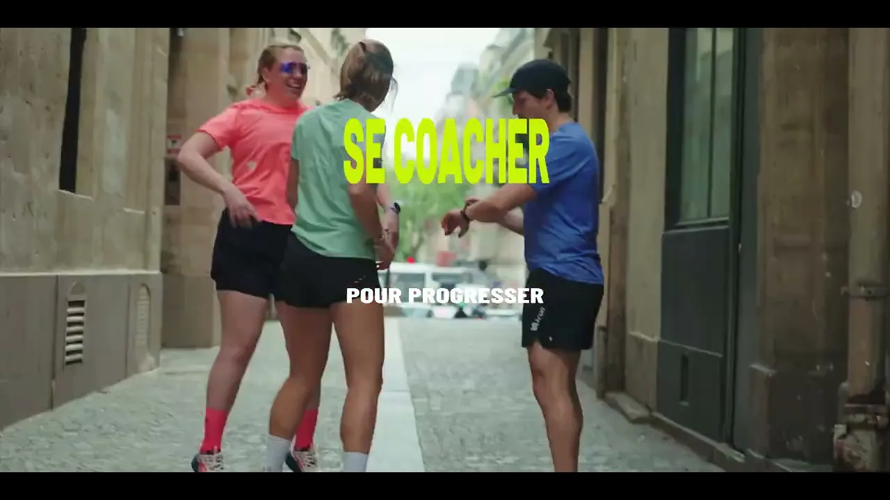The video opens with a group of people running on a grassy, hilly terrain with a bright blue sky. The camera is low and…