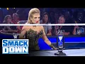Scarlett places an hourglass in front of Roman Reigns