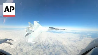 shows Russian jet flying within feet of US F-16 near Alaska