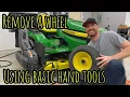 How to remove a wheel from a John Deere lawn tractor using basic tools