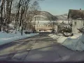 Tesla Model Y driving around the City Of Peekskill down the hill with mountain views