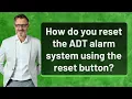 How do you reset the ADT alarm system using the reset button