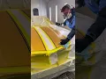 Painting racing stripes on a Chevy Camaro