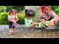 Download Lagu Mother and daughter cross streams to bring their farm produce to market to sell.