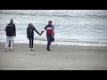 Macron and his wife walk along Le Touquet beach