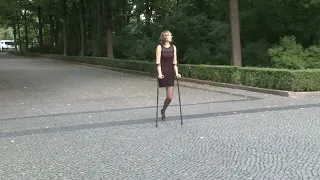 amputee woman crutching in the park