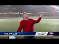 Doug Meehan gets soaked by sprinklers in Dodger Stadium