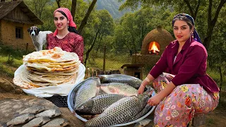 طبخ قرى الشرق الأوسط سمك مشوي على النار وخبز طيني تقليدي 