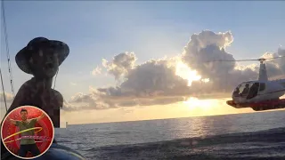 HELICOPTER BRINGS FISH TO OUR SAILBOAT FOR SEEING BOOBIES