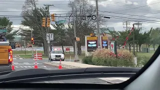 Berkeley Township Police crown Victoria assisting construction workers fixing pole that fell