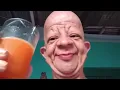 bald guy drinks orange juice