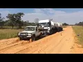 Landcruiser pulls out truck stuck in mud
