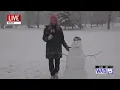 Marleigha Patrick make a snowman in Monday s storm