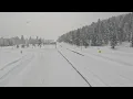 Snow falls on nearly deserted interstate in Truckee California