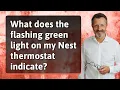 What does the flashing green light on my Nest thermostat indicate