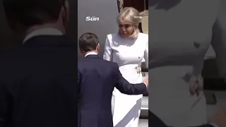 Moment Brigitte Macron rejects husband s help leaving plane after viral slap vid