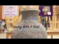 Using a grid to carve a pattern on coil pottery