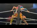 Asuka using Becky and Carmella s faces as a seat during the stinkface